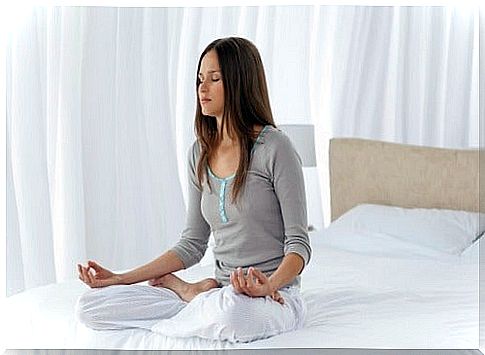 Woman meditating on the bed