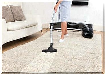 Woman vacuuming the carpet.