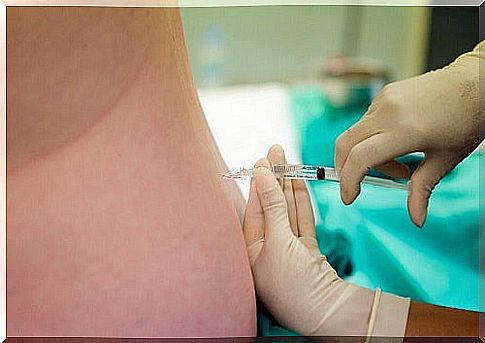 Nurse performs puncture on patient abdomen