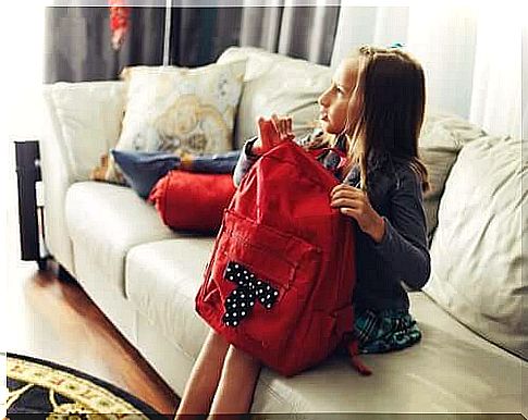 Little girl opening school backpack