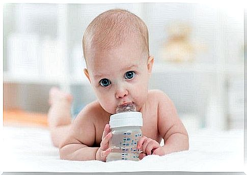 Baby boy drinking water.