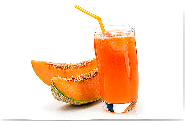 Glass with melon juice and melon slices