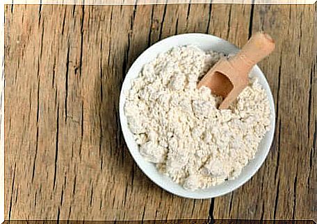 Colloidal oats with wooden bowl and measuring cup.