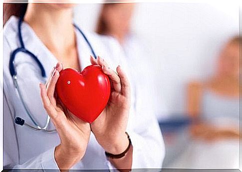 female doctor with fake heart in hand