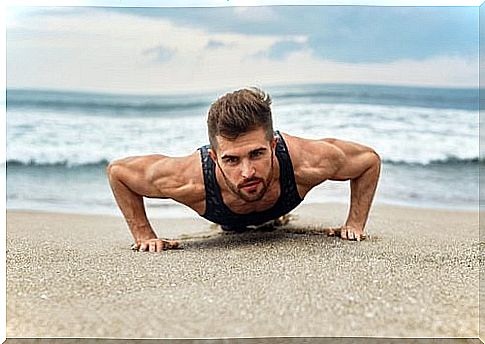 Boy is exercising at the beach