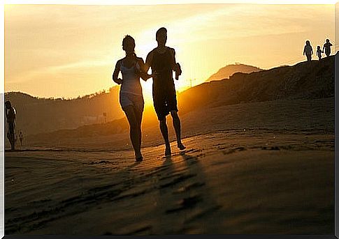 Couple running at sunset