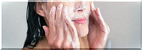 Woman exfoliating her face.