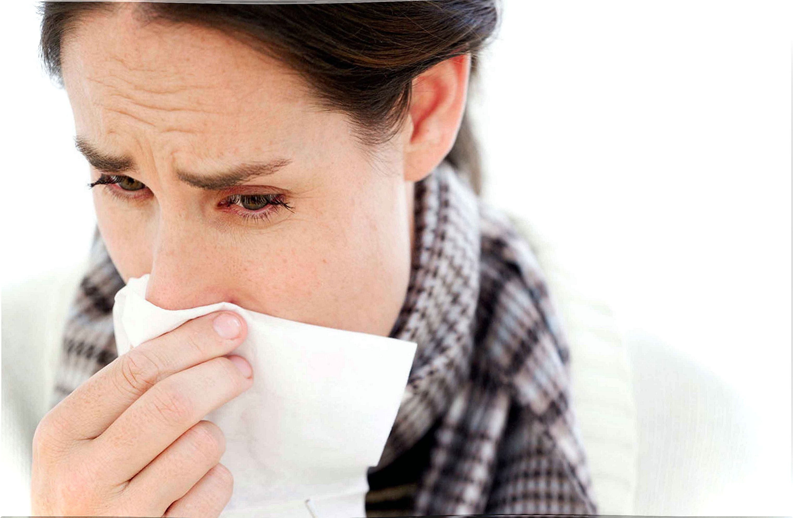 Woman blows her nose with handkerchief