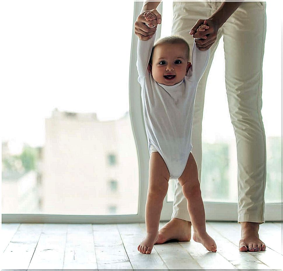 Parent helping the child to walk