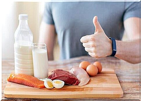 Man in front of cutting board with protein foods