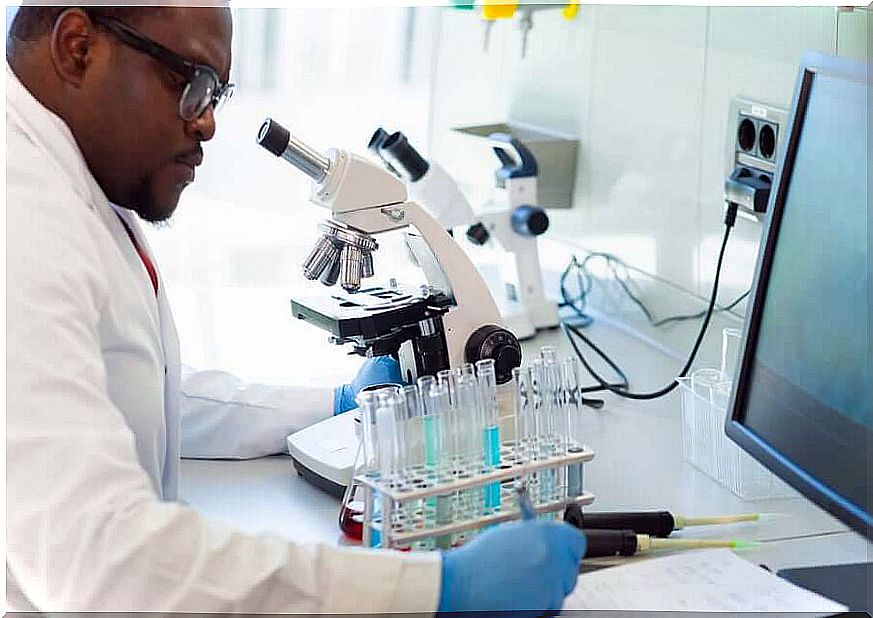 Viral load, researcher with test tubes and microscope