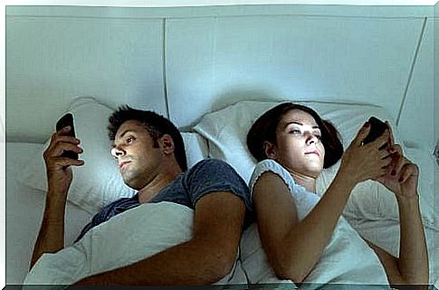 couple in bed with cellphone